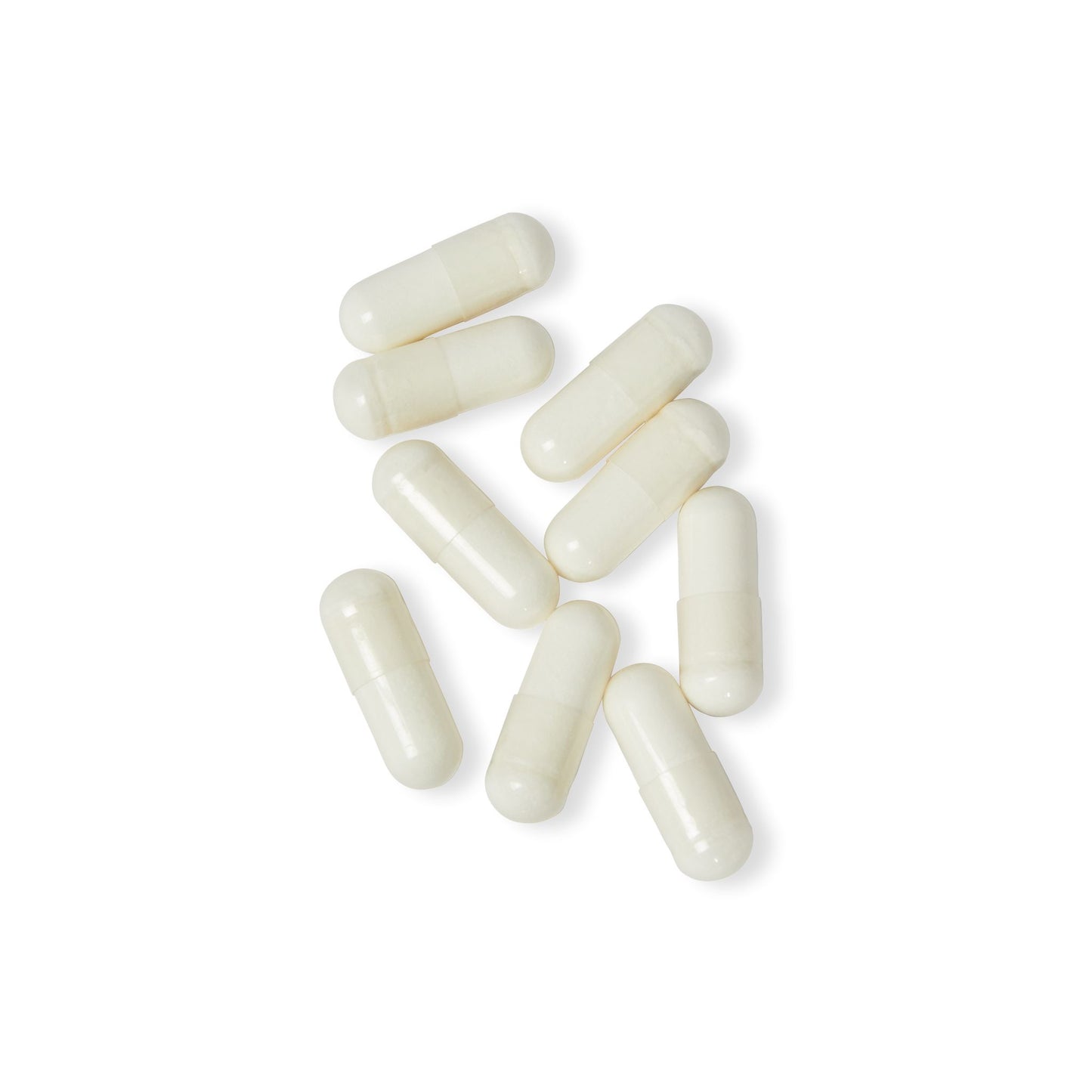 Close-up of Katherine Home Magnesium Glycinate white capsules arranged on clean background.