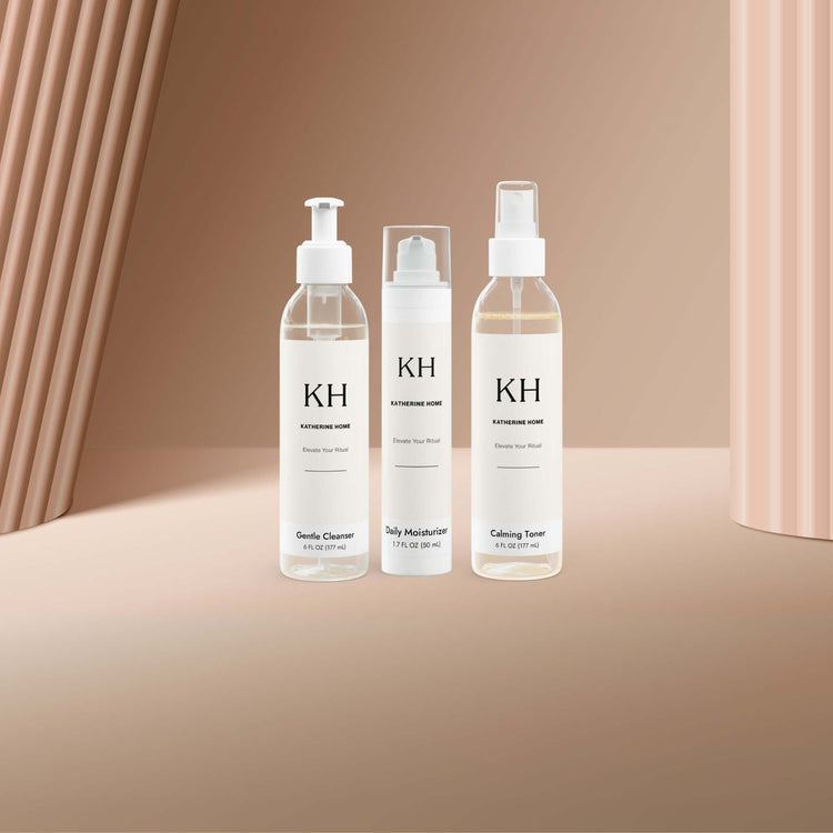 Katherine Home luxury skincare bottles and jars arranged on a clean white background with a soft, elegant glow.