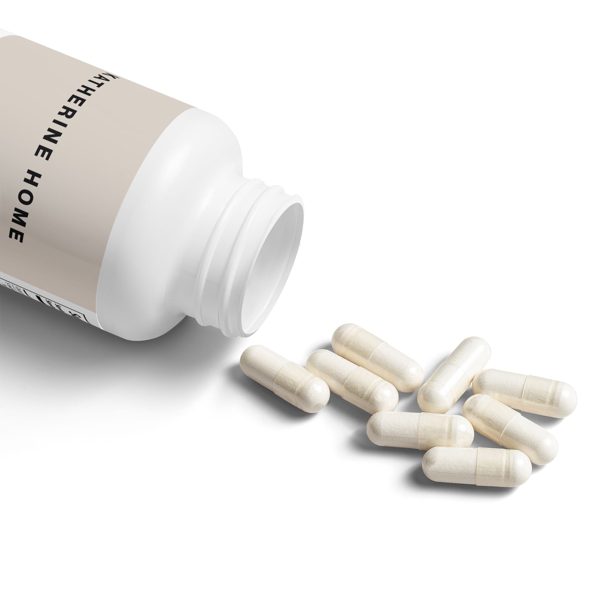 White supplement bottle with capsules spilling out on a white background