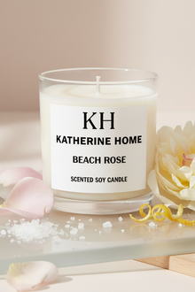 Scented soy candle labeled 'KH Katherine Home Beach Rose' with decorative elements on a light background