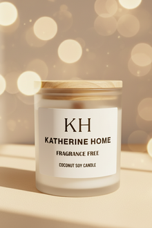 Candle with a wooden lid labeled 'KH Katherine Home' on a neutral background