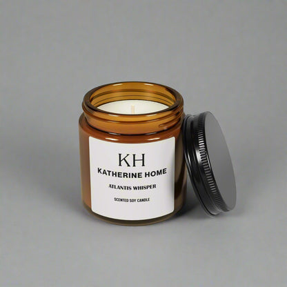 Atlantis Whisper 4oz Candle with notes of soft dark musk, ocean breeze, and sandalwood in an amber jar with lid open.