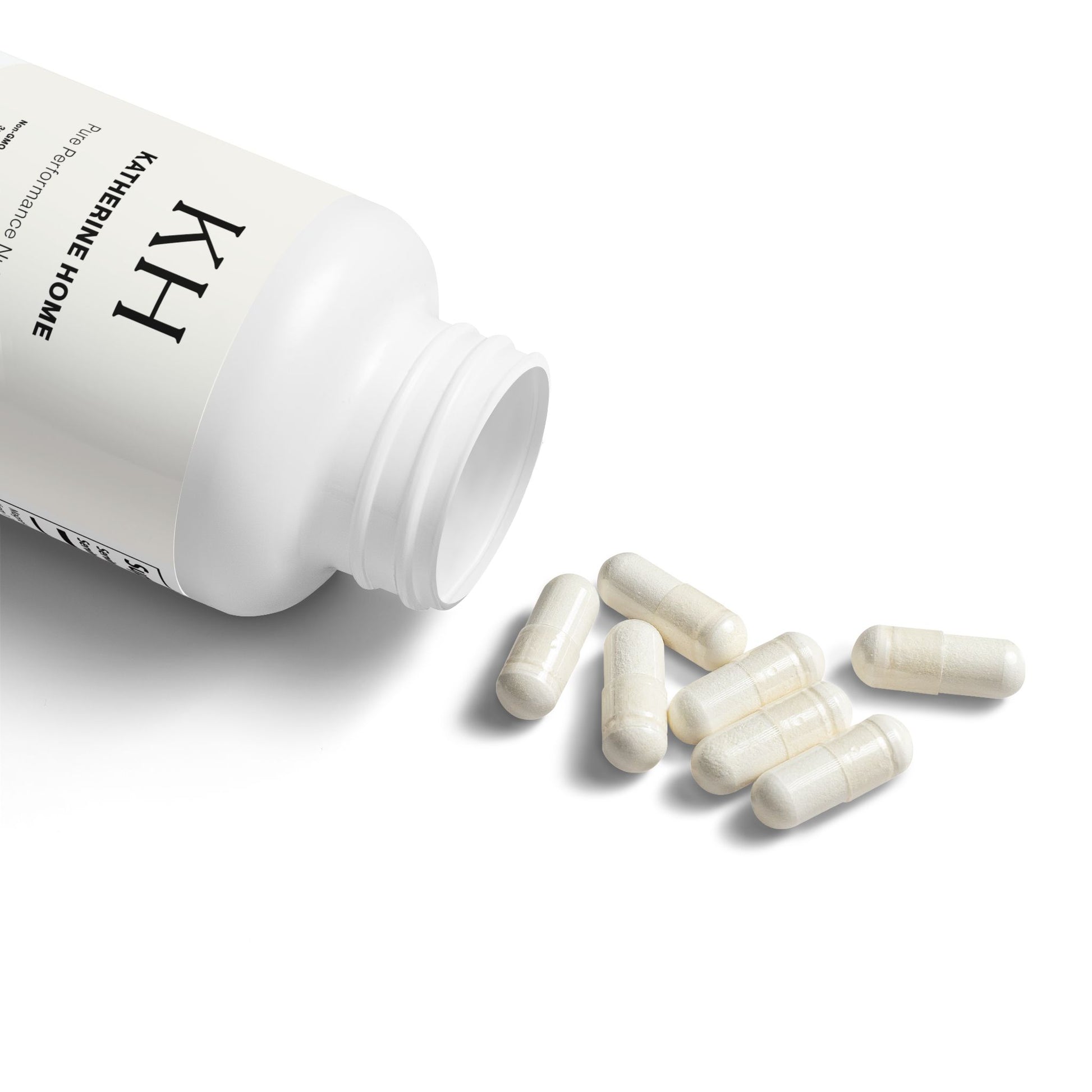 Katherine Home Magnesium Glycinate capsules pouring from open white bottle.