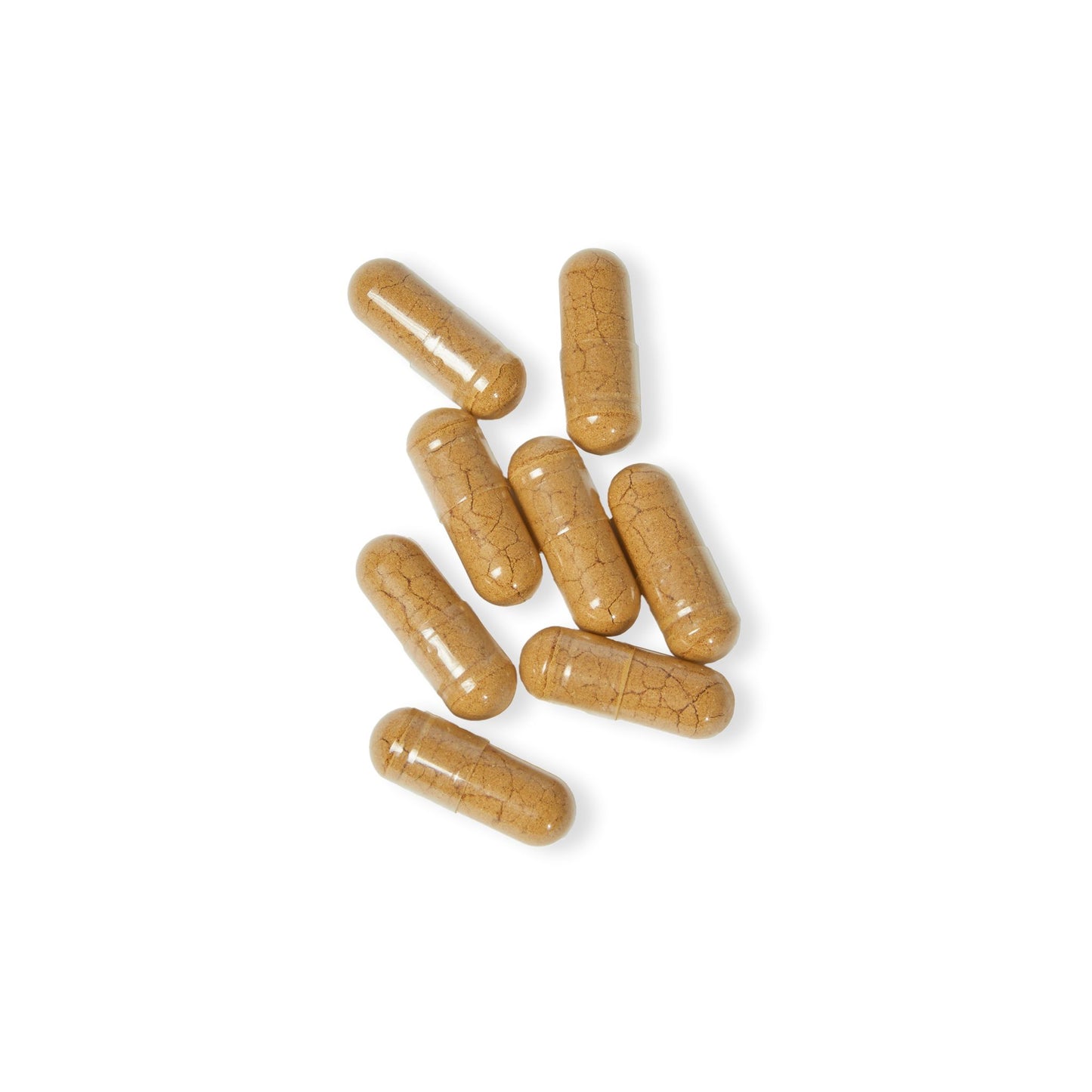 Close-up of Katherine Home Mushroom Blend Supplement vegetable capsules arranged on a white surface.