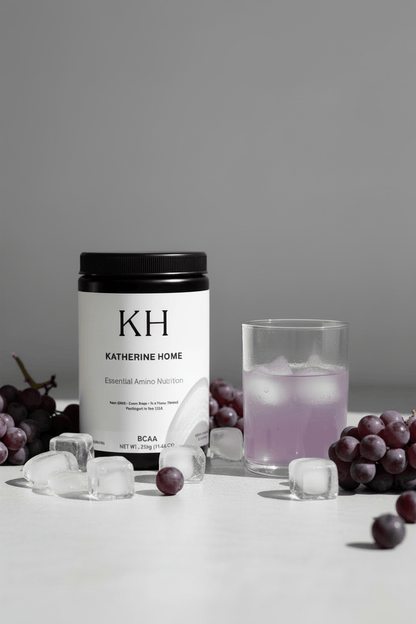 BCAA Supplement, Grape - KATHERINE HOMEFood SupplementsKATHERINE HOMEKATHERINE HOMEKatherine Home BCAA Grape supplement styled in a calm wellness setting with a lightly tinted grape hydration drink and soft natural light.