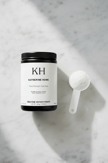 Creatine Monohydrate Supplement - KATHERINE HOMEFood SupplementsKATHERINE HOMEKATHERINE HOMETop view of Katherine Home Creatine Monohydrate supplement with a white scoop of finely milled powder on a light stone surface.