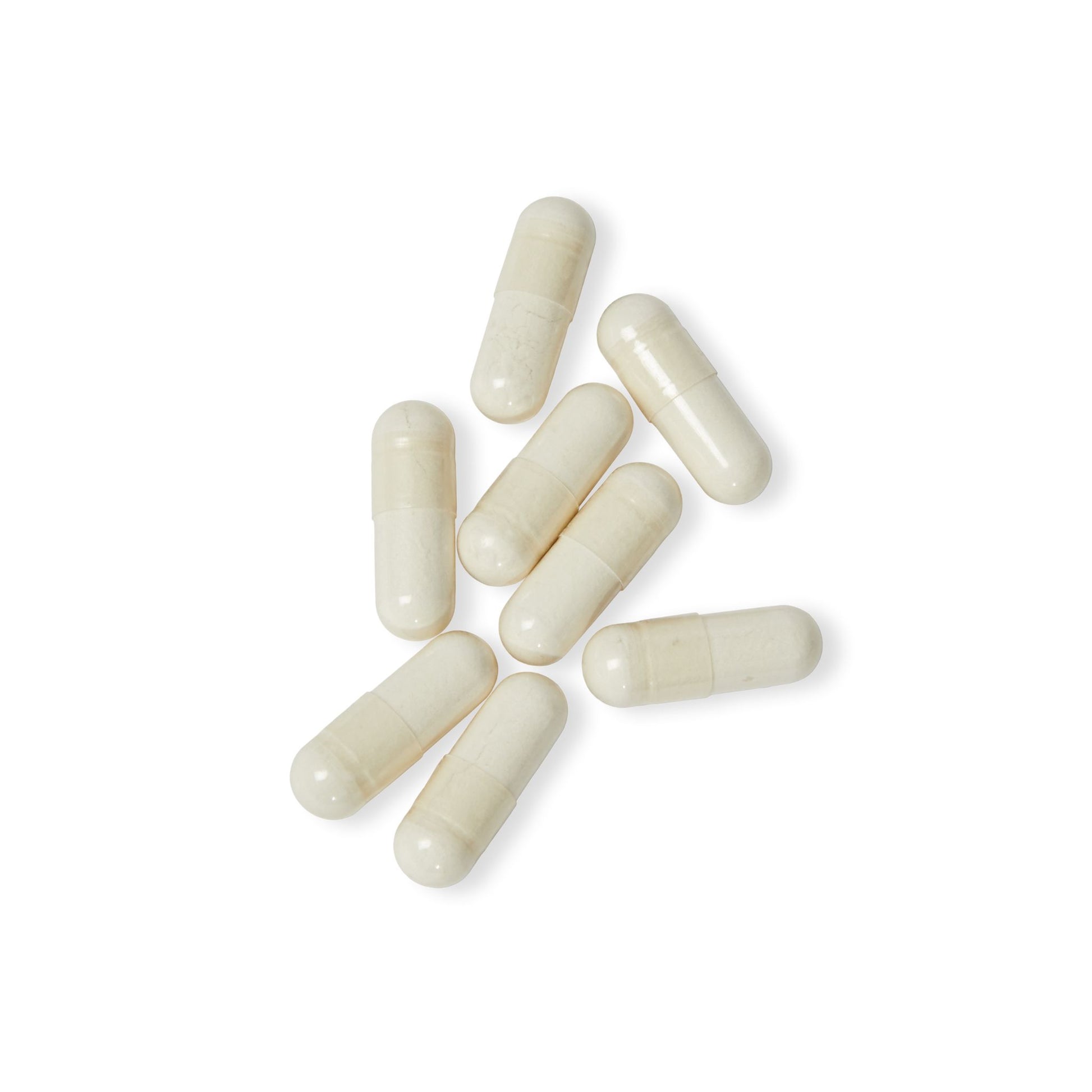 Close-up flat lay of Katherine Home 5-HTP capsules on a white surface, highlighting their smooth capsule form.
