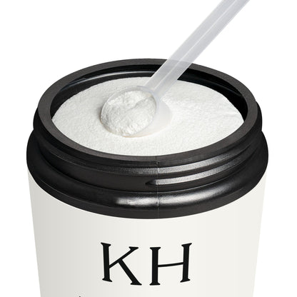 Open jar of Katherine Home BCAA Grape showing purple-tinted powder and scoop inside matte black container.