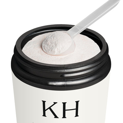Open jar of Katherine Home BCAA Watermelon showing pinkish powder and measuring scoop inside matte black container.