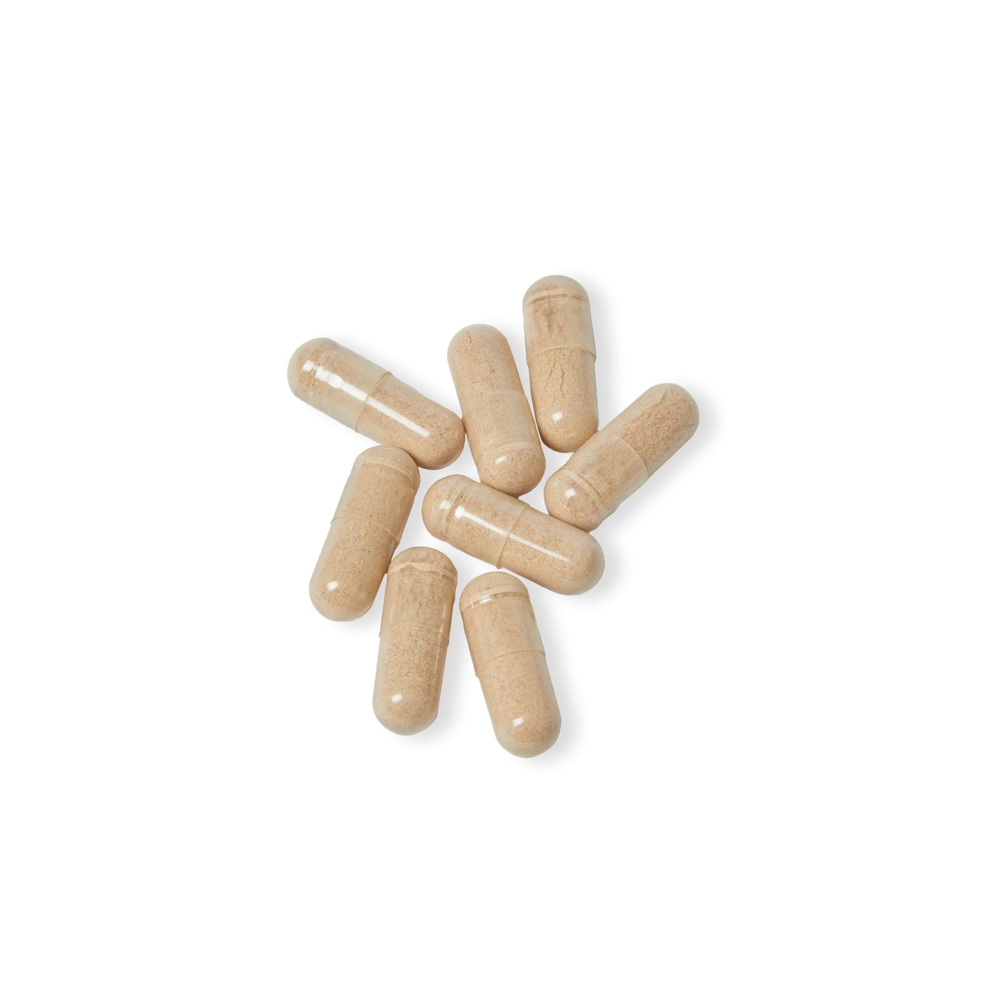 Close-up flat lay of Katherine Home Brain Support Complex capsules on a white surface, emphasizing capsule texture and purity.
