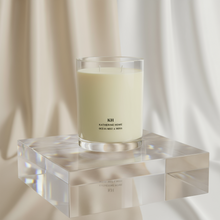Ocean Mist & Moss Scented Candle on a glass stand, evoking coastal freshness and modern elegance.
