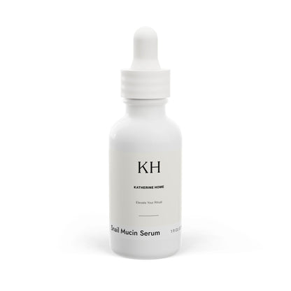Front view of Katherine Home Snail Mucin Facial Serum in white 1 oz dropper bottle