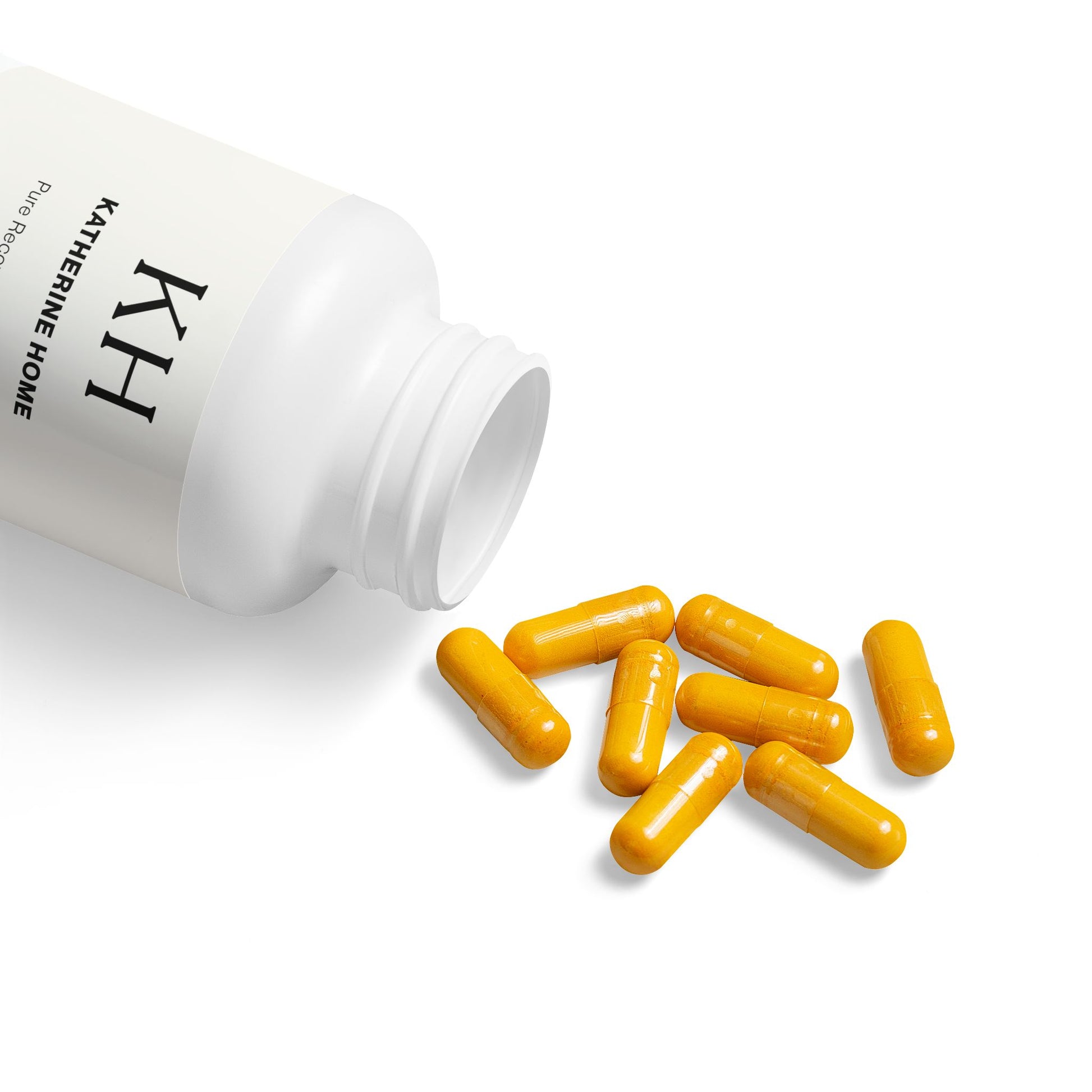 Open bottle of Katherine Home Turmeric with BioPerine Supplement showing bright yellow capsules spilling out.