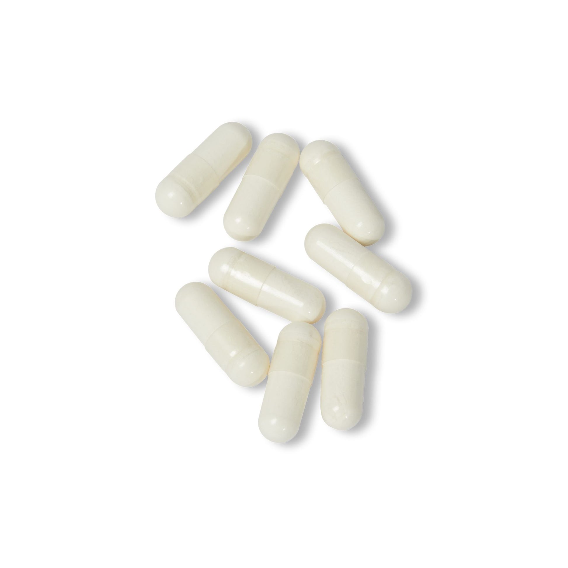 White Vitamin K2 + D3 supplement capsules displayed close-up on a white background.