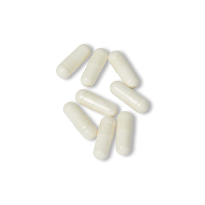 White Vitamin K2 + D3 supplement capsules displayed close-up on a white background.
