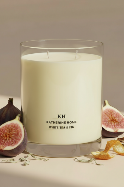 Katherine Home White Tea & Fig Candle displayed beside sliced figs, showing the natural fragrance inspiration.