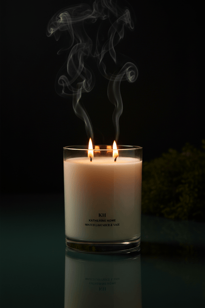 Dramatic dark luxury portrait of Katherine Home Minted Lavender & Sage candle in a calm spa - inspired setting.