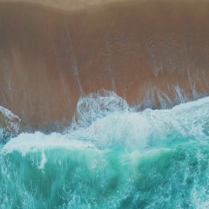 Video of ocean waves rolling onto the shore, representing the fresh, coastal scent of the Katherine Home Ocean Mist & Moss candle.