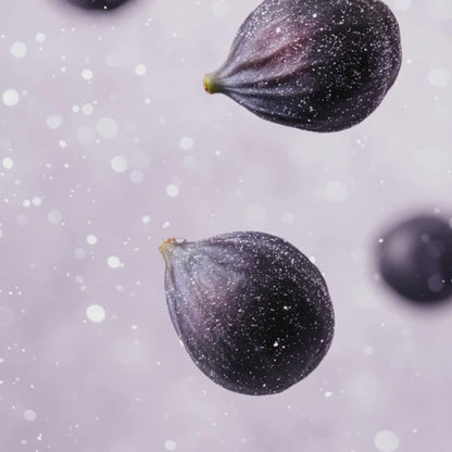 Slow-motion video of fresh figs falling against a soft background, illustrating the fruity scent notes of White Tea & Fig Candle.